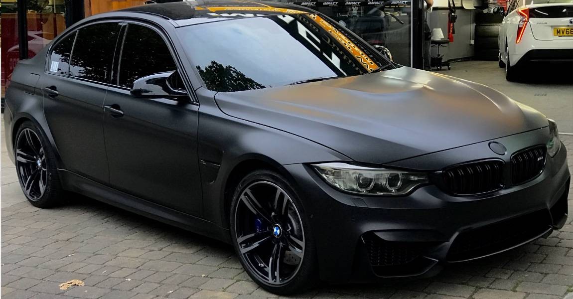 Matte black BMW M3 with tinted windows