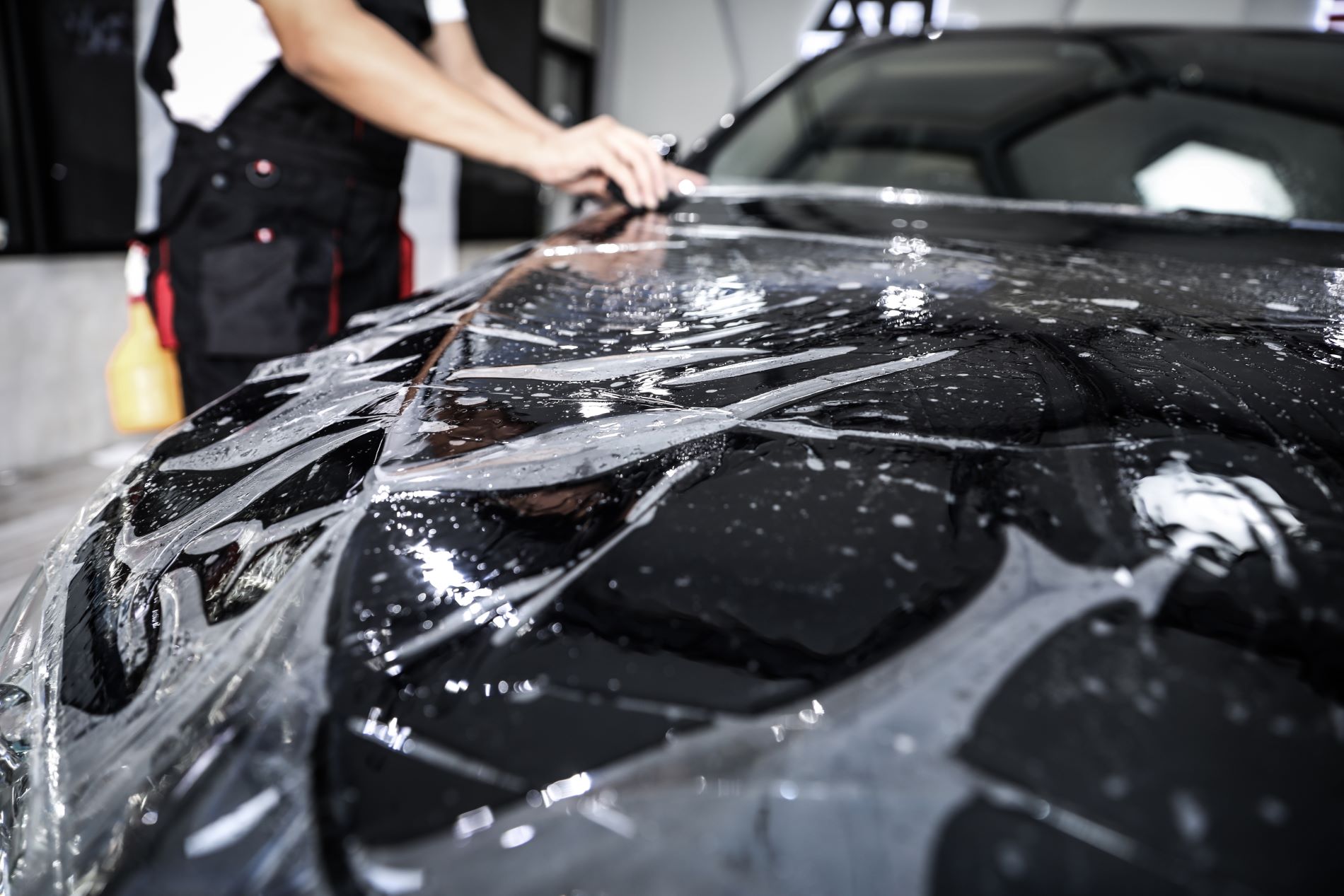 Close-up of paint protection film being fitted to a car